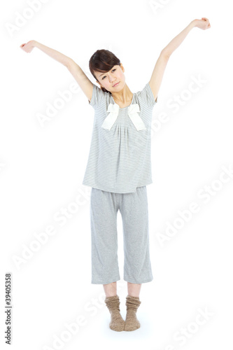 Woman morning stretching in pajamas