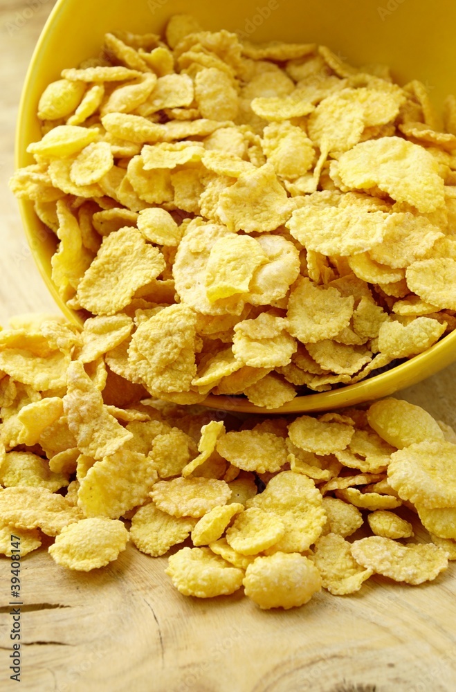 inverted bowl of yellow corn flakes on the table