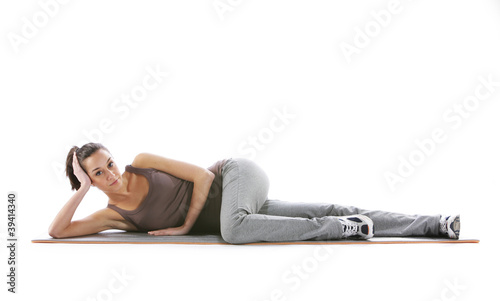 Fitness woman doing fitness exercise on mat . White background