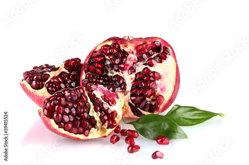 ripe pomegranate fruit with leaves isolated on white