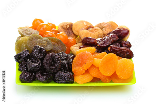 delicious dried fruits on plate isolated on white