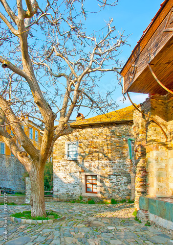 Old buildings and a tree in Iviron monastery on Athos Greece