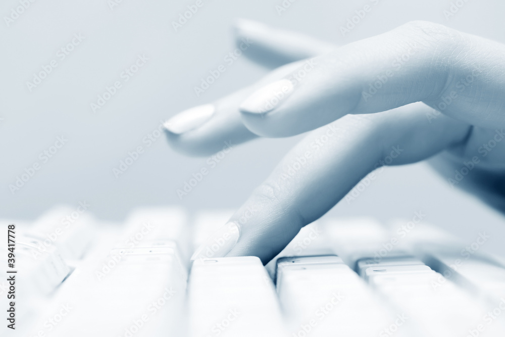 Female hand typing on computer keyboard Female hand typing on computer keyboard