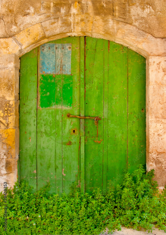 Green colored door in a building located in Limassol Cyprus