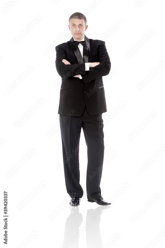 The elegant man in a classical tuxedo on a white background The elegant man in a classical tuxedo on a white background