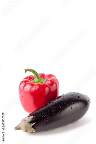 Eggplant and red bell pepper, white background, copyspace