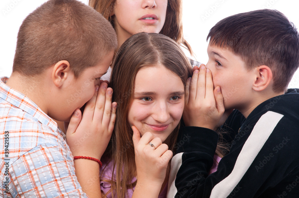 Teenagers gossiping about their mutual friend Teenagers gossiping about their mutual friend