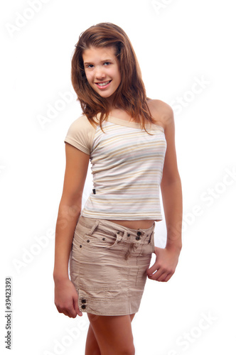 Canvas Print Beautiful smiling teenage girl posing in short brown skirt