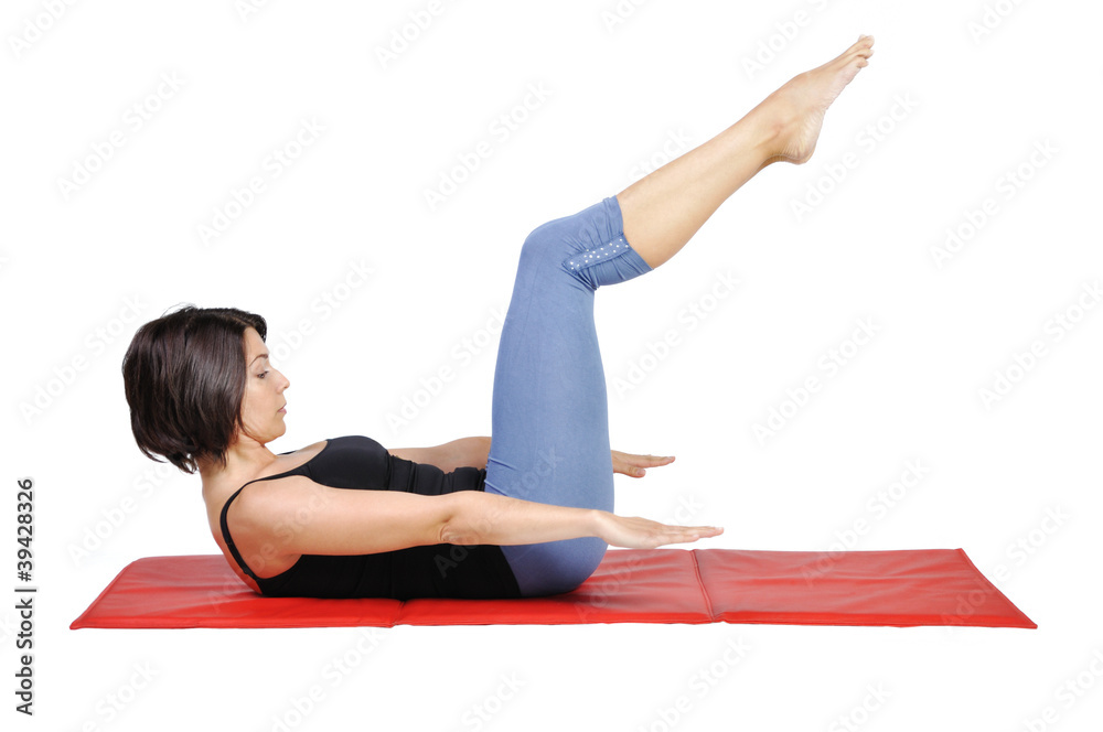 Fit young female pilates instructor showing different exercises Fit young female pilates instructor showing different exercises