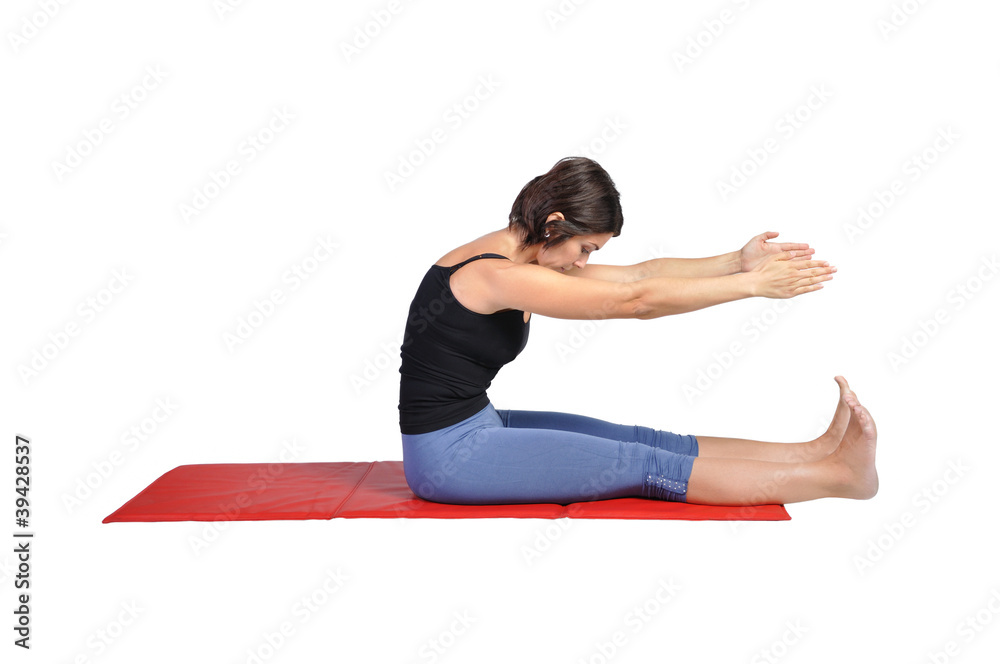 Fit young female pilates instructor showing different exercises Fit young female pilates instructor showing different exercises