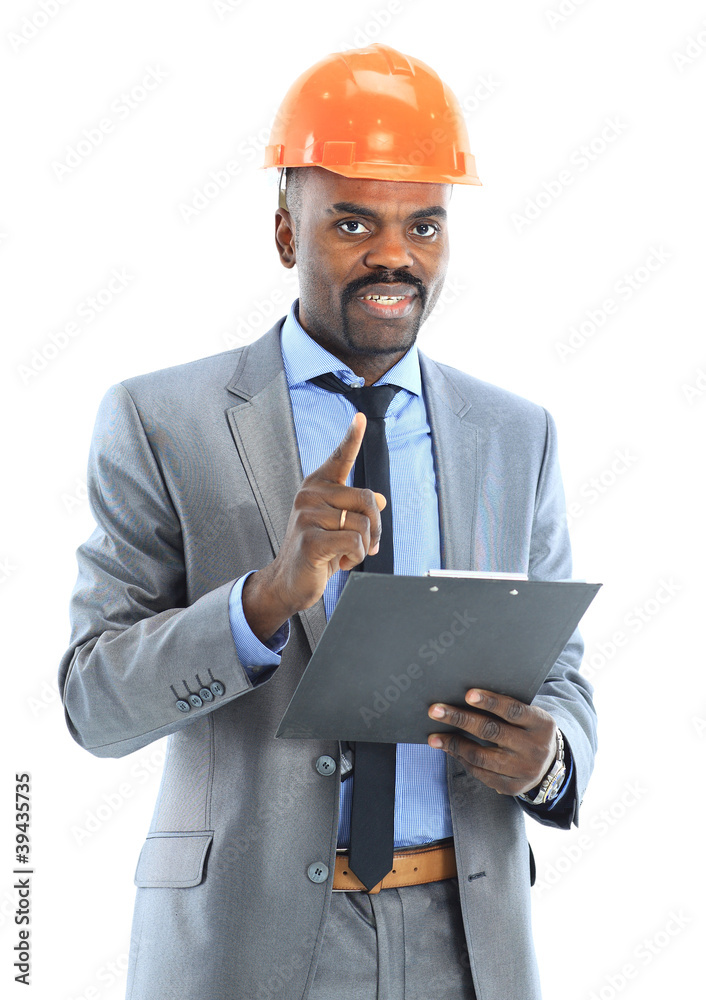 Confident ethnic architect wearing a hardhat against Confident ethnic architect wearing a hardhat against