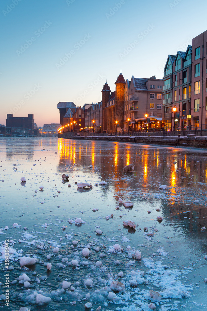 Fototapeta premium Old town in Gdansk with frozen Motlawa river at dusk, Poland