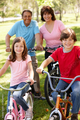 Hispanic family riding bikes in park