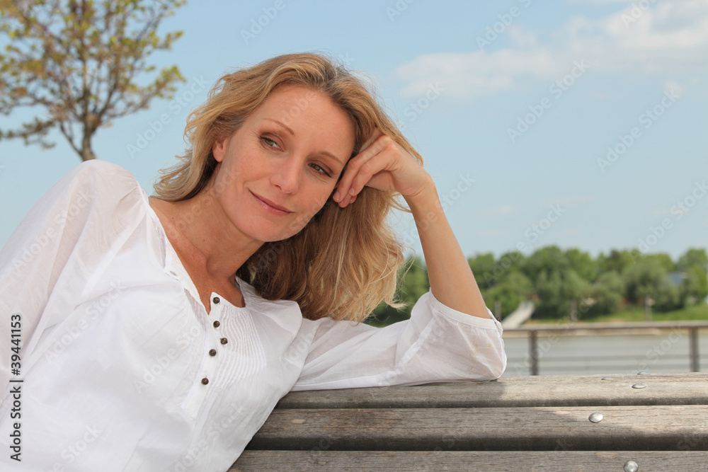 Daydreaming woman on a park bench Daydreaming woman on a park bench