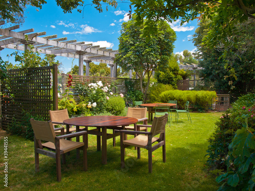 Fotótapéta dining table set in lush garden