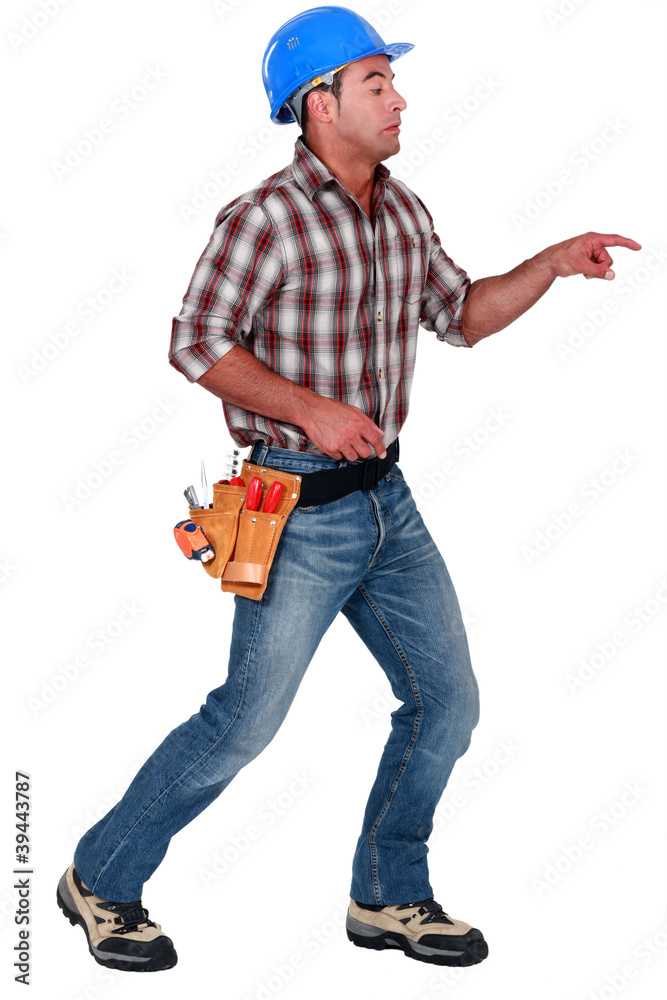 A male construction worker poking something scary. A male construction worker poking something scary.