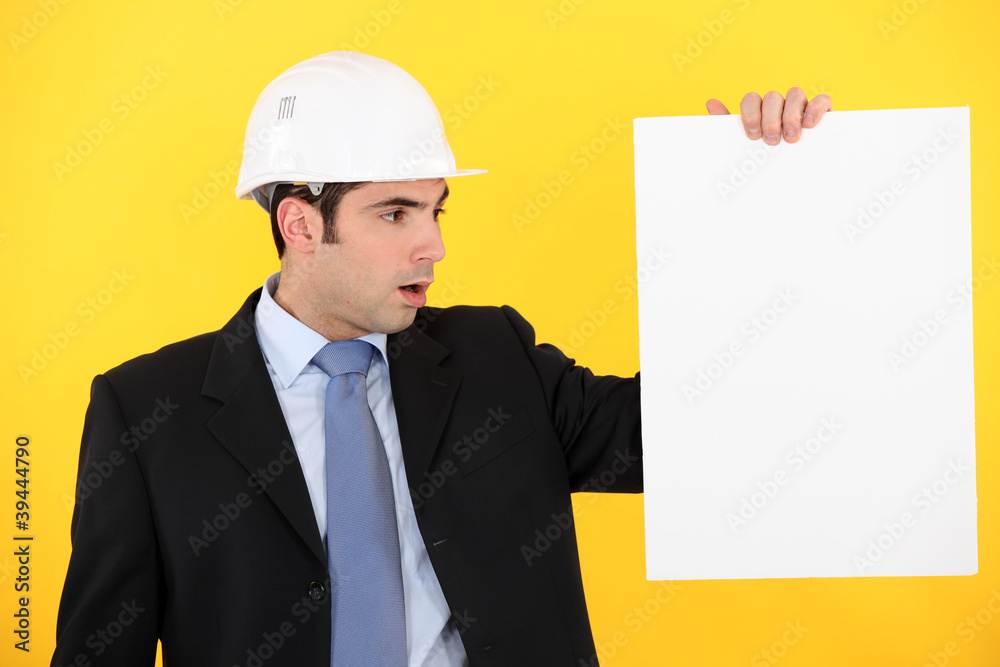 Architect stood with blank poster Architect stood with blank poster