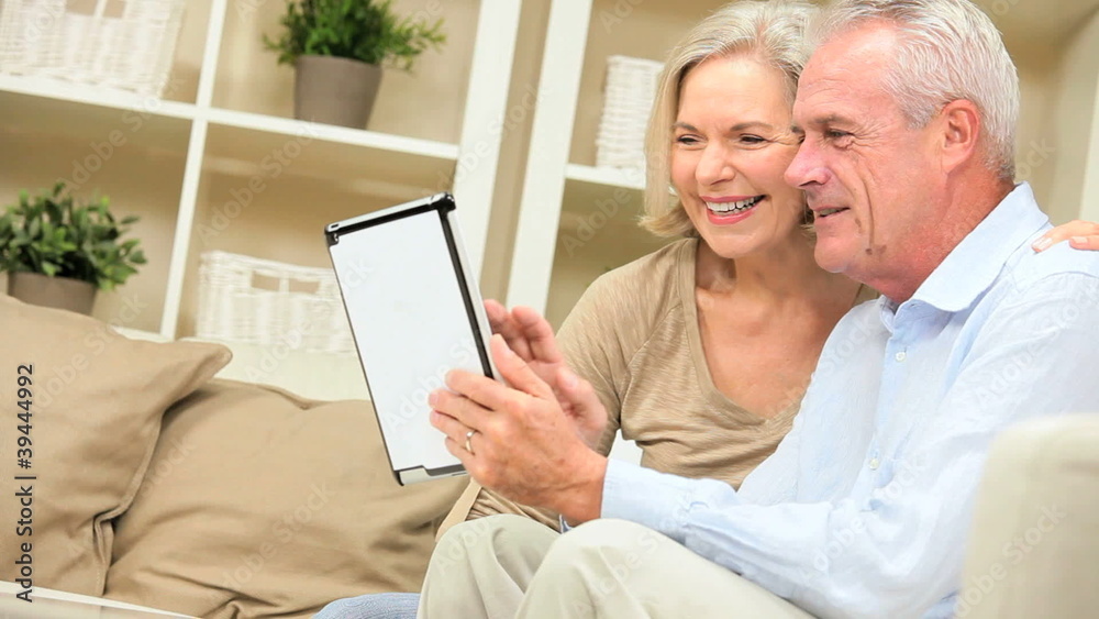 Retired Couple Using Wireless Tablet Technology Retired Couple Using Wireless Tablet Technology