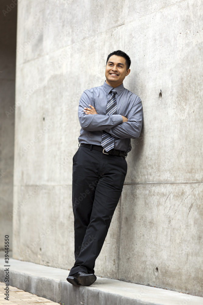 Hispanic Businessman - Leaning On Concrete Wall Hispanic Businessman - Leaning On Concrete Wall