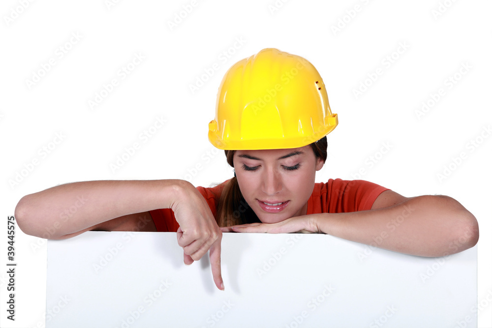 craftswoman pointing at a blank ad board craftswoman pointing at a blank ad board