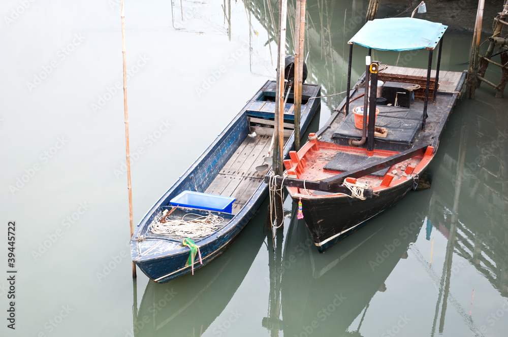 two fishing boats anchor in the dock