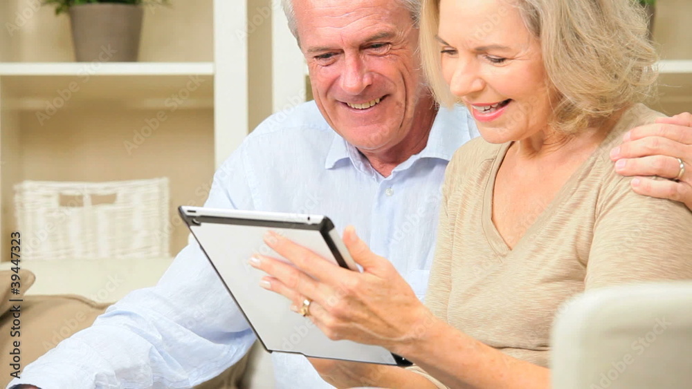 Retired Couple Using Wireless Tablet Technology Retired Couple Using Wireless Tablet Technology
