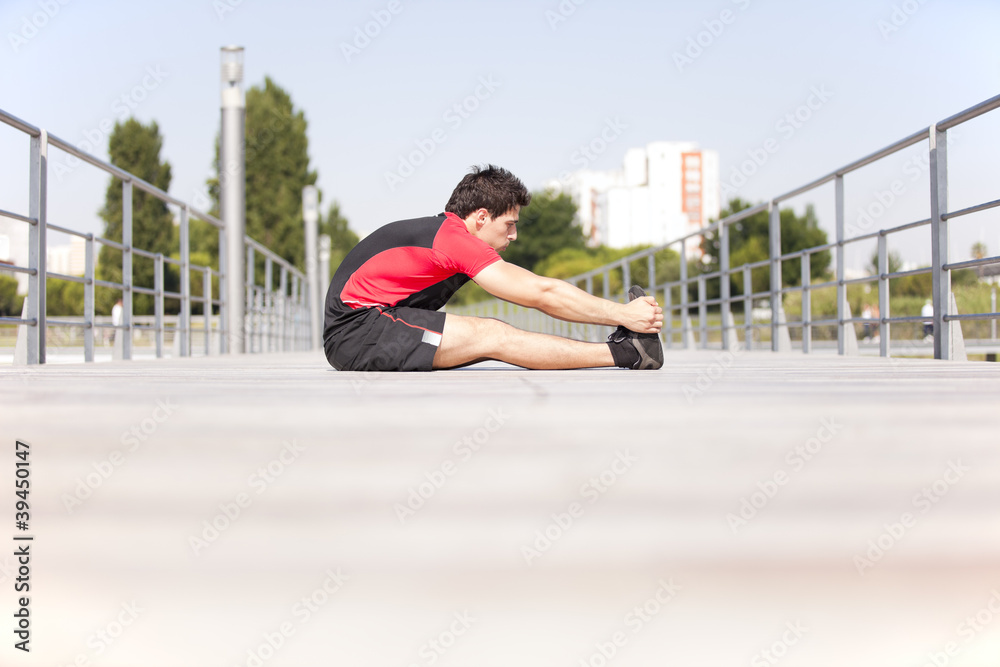 Fototapeta premium Athlete warming and stretching