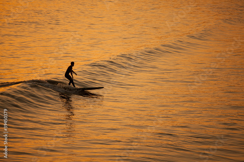 Fototapeta Naklejka Na Ścianę i Meble -  Single California surfer at sunset