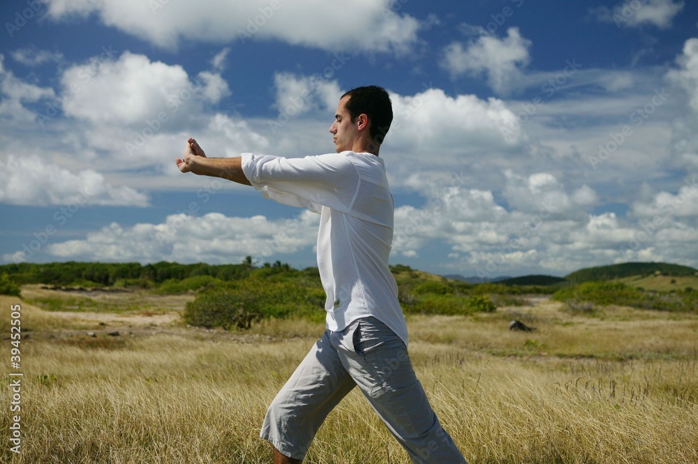 Man meditating in the countryside Man meditating in the countryside