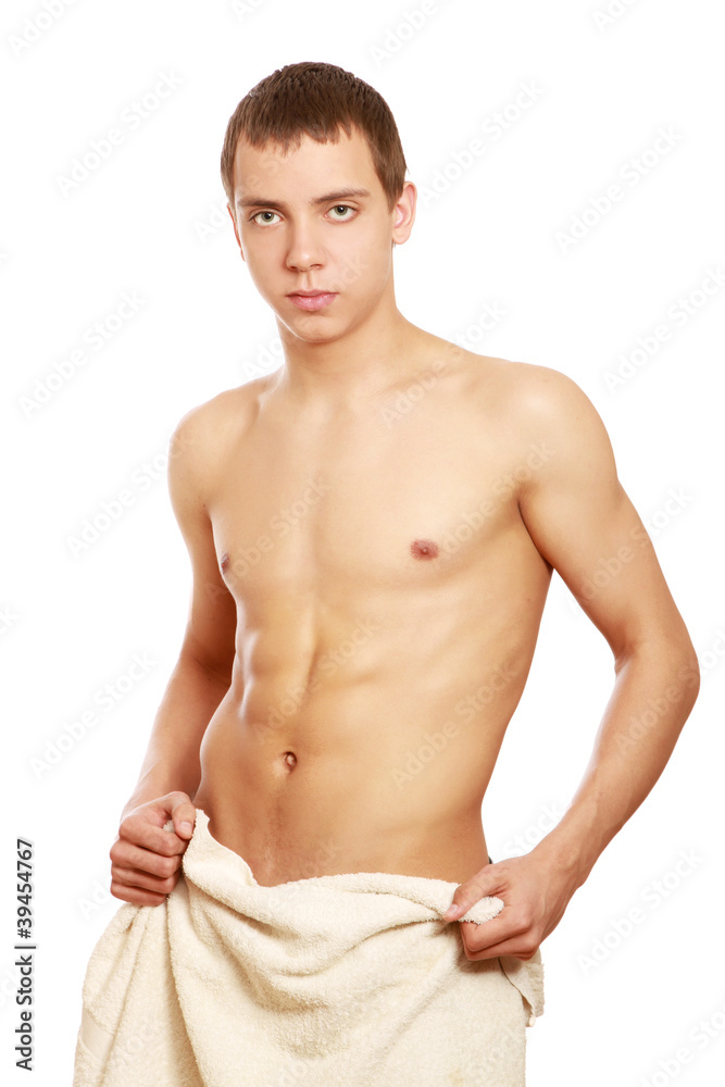 A nude young man covering himself with a towel A nude young man covering himself with a towel