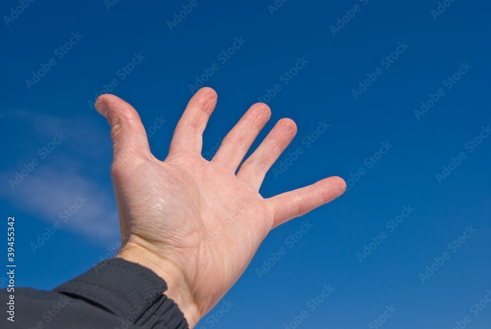 people hand on a blue sky background people hand on a blue sky background