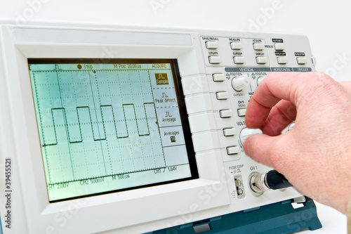 Engineer Operating a Digital Oscilloscope