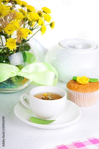 breakfest with tea, cake and yellow flowers