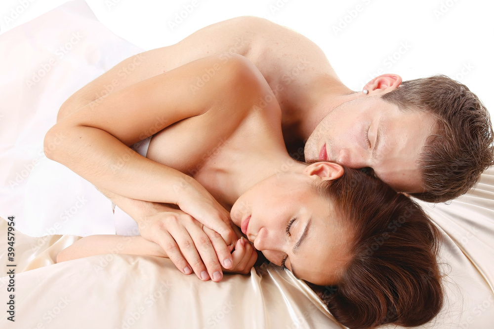 Loving affectionate nude heterosexual couple on bed Loving affectionate nude heterosexual couple on bed