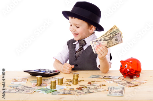 Boy at the table counts money