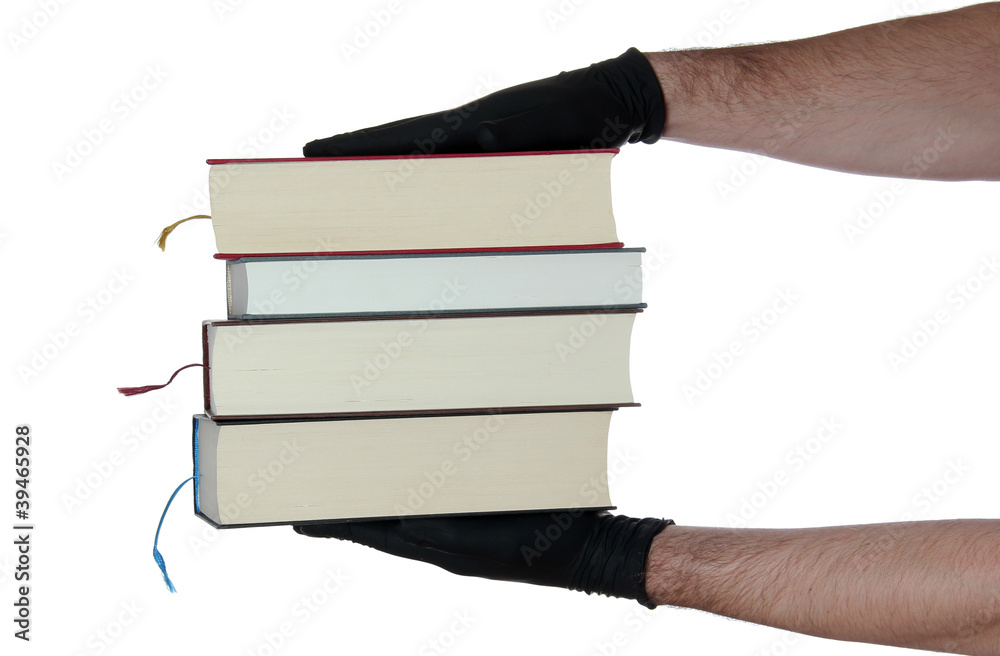 stack of books in hands with black gloves stack of books in hands with black gloves