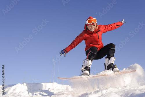 Young woman on snowboard