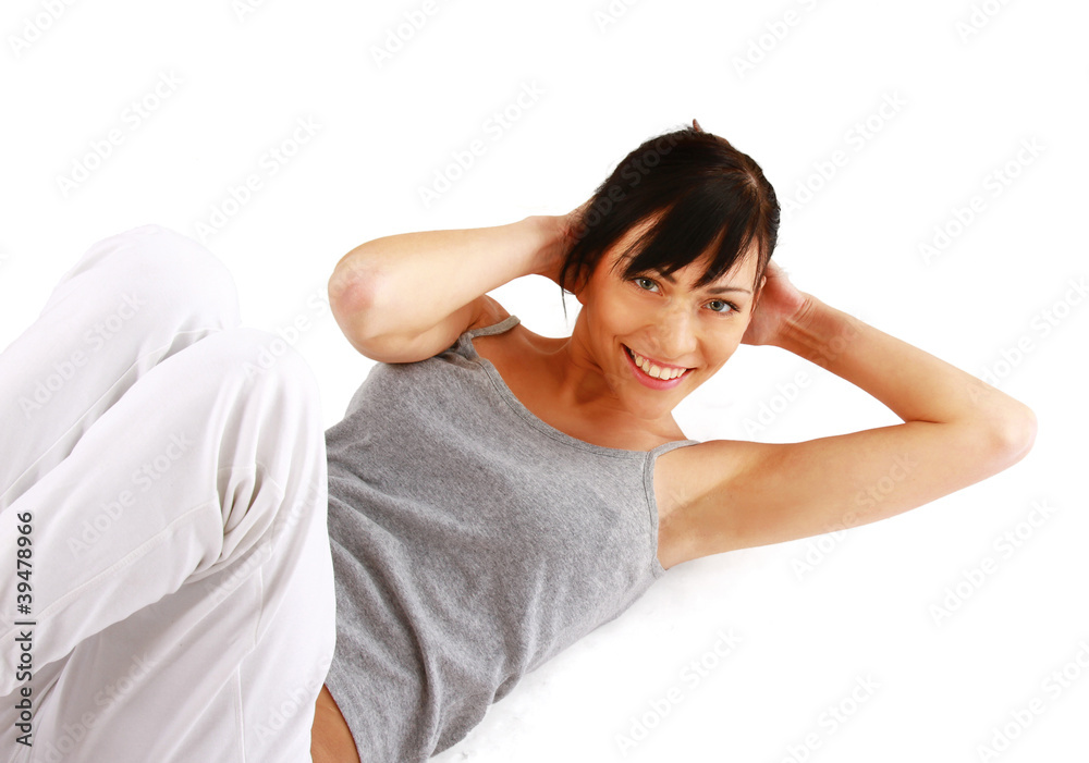 A young woman doing exercises, pumping a press A young woman doing exercises, pumping a press