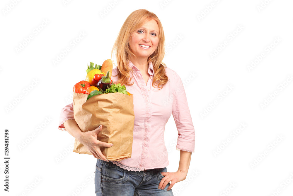 Smiling woman holding a paper bag full of groceries Smiling woman holding a paper bag full of groceries