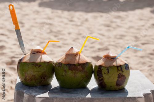 coconuts and with tubes knife on the beach
