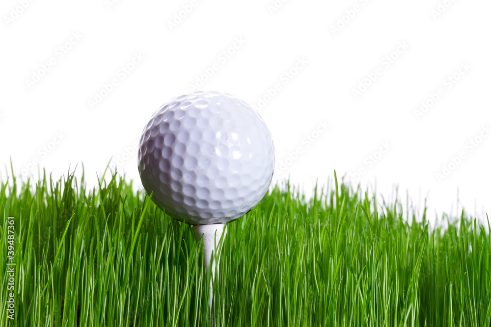 Golf ball on the tee in green grass over white Golf ball on the tee in green grass over white
