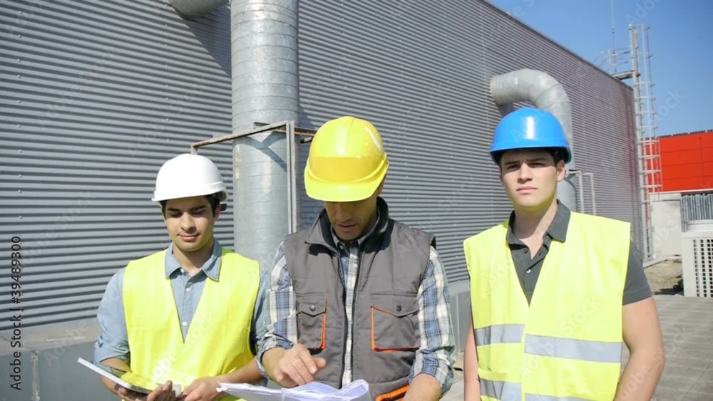 Young people in professional training on industrial site