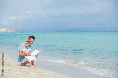Happy father and his son playing at beach