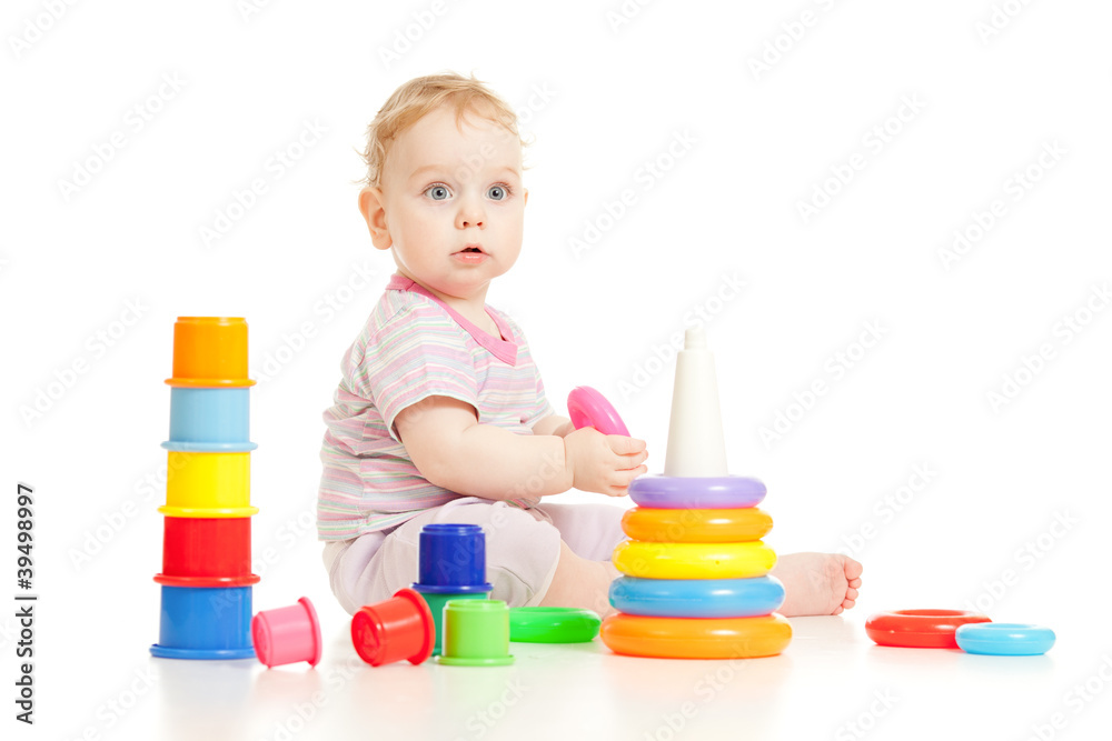Cute little boy playing colorful toys isolated on white Cute little boy playing colorful toys isolated on white