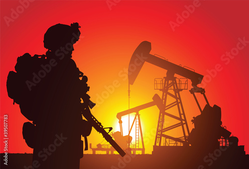 US soldier with oil rigs on the background