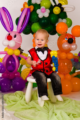 Cute baby in balloon forest
