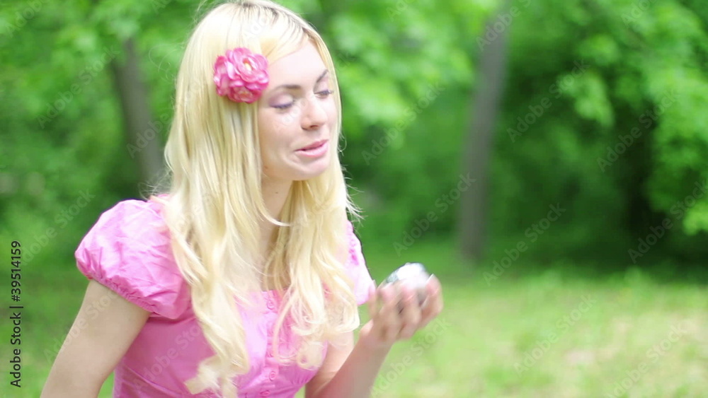 Beautiful girl brushing her hair, outdoor video. Beautiful girl brushing her hair, outdoor video.