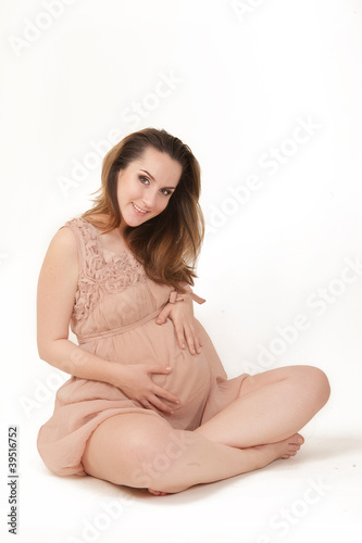 beautiful pregnant woman on white background. 7 months