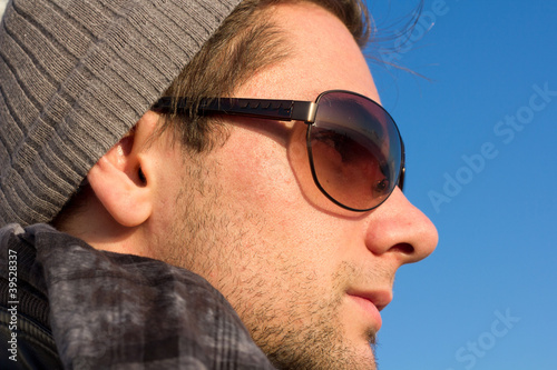 Brunette Man With Sunglasses And A Hat Looking