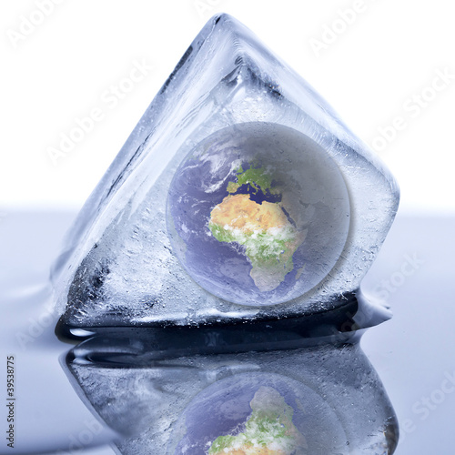 Frozen earth globe inside the ice cube photo